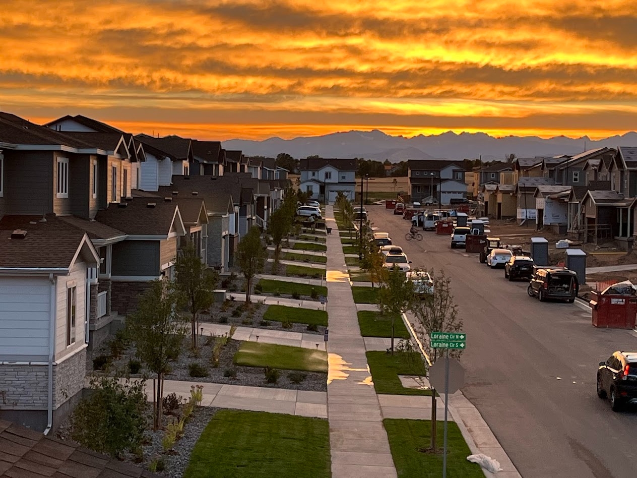 Pink and blue sunset with mountain range visible down the neighborhood street