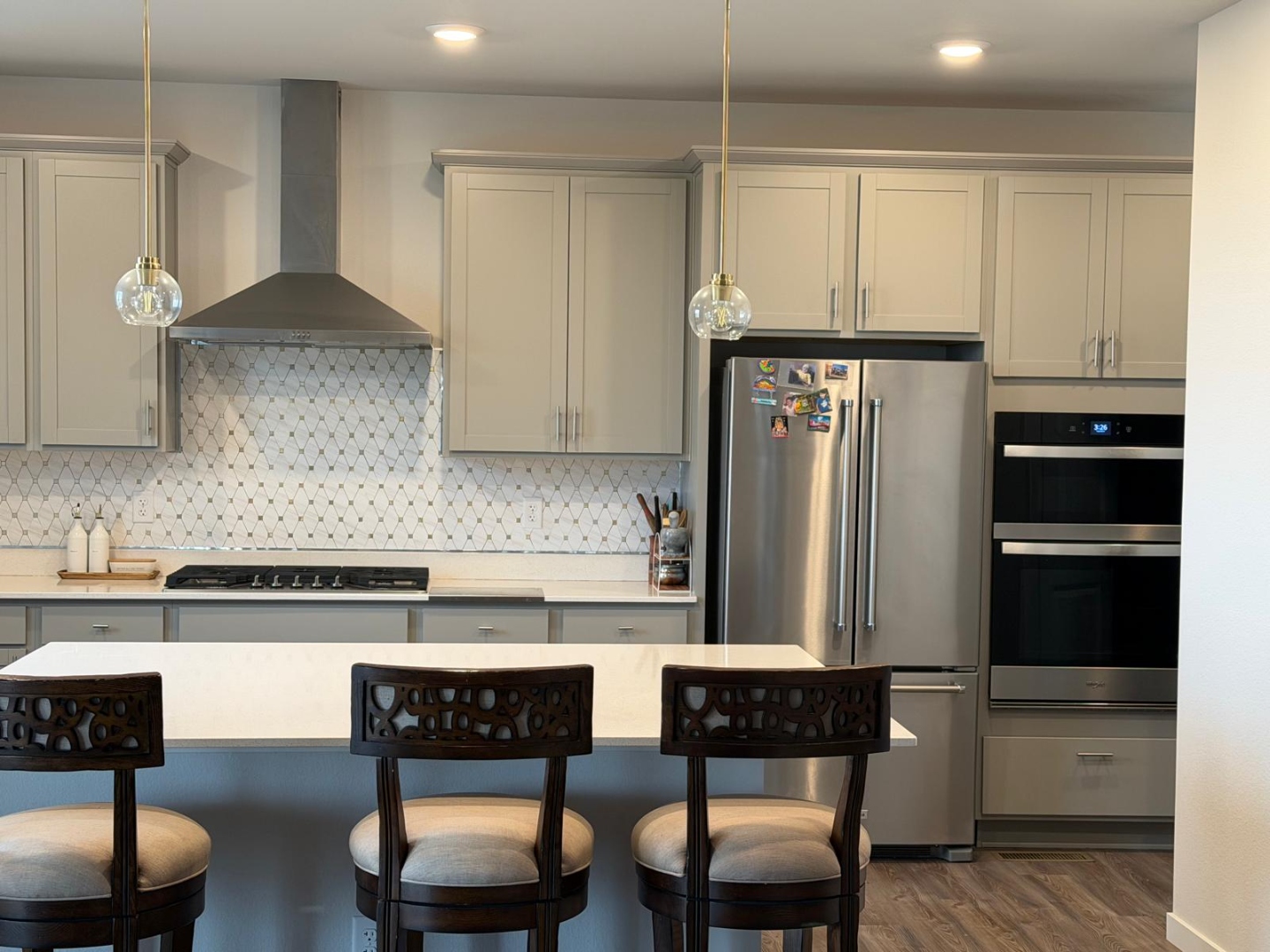 Kitchen with island facing toward backyard and living spaces